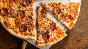 Fresh pizza leftovers ready for wrapping and refrigerating.